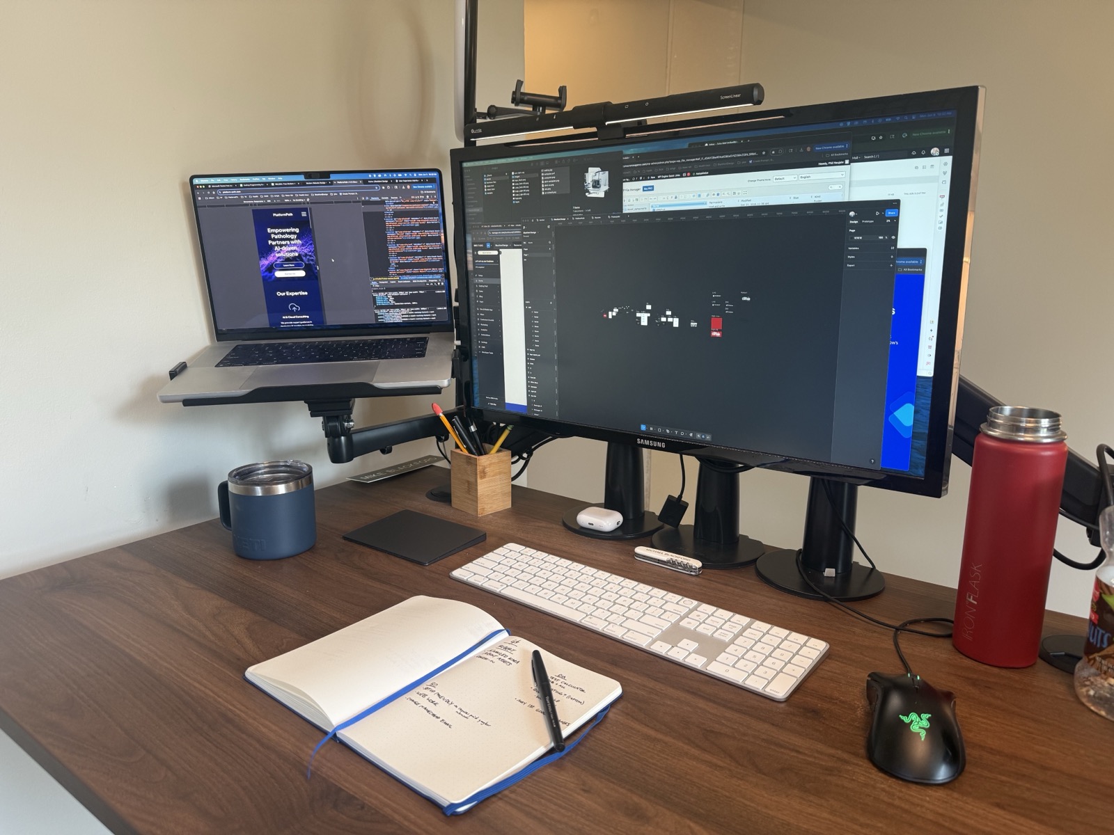 Design workstation with website and code on screen